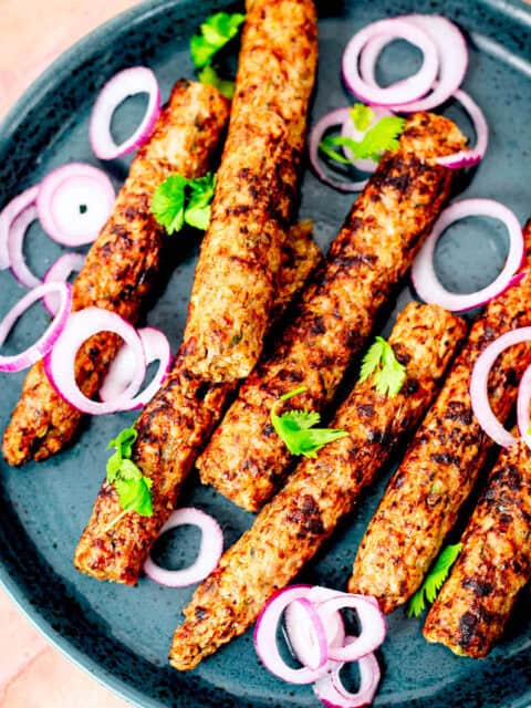 Chicken Seekh Kebab in plate with red onions